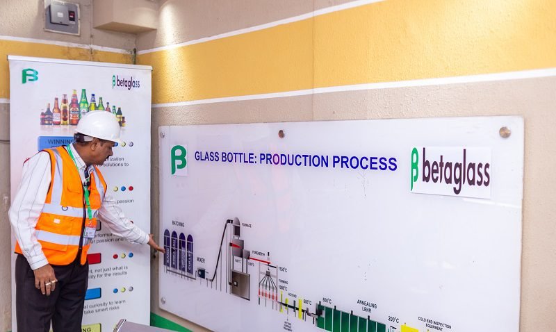 Jagdish Agarwal, Beta Glass COO, showing the process of glass bottle production using an infographic on the wall. 