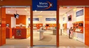 Front view of a Maroc Telecom store with an orange and white interior, displaying mobile phones and telecom services