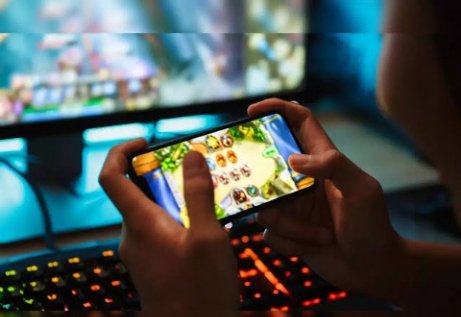A picture of human hands with a phone in it showing mobile gaming.