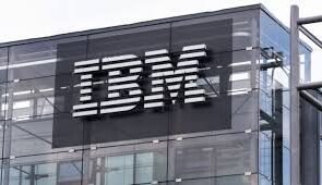 A picture of IBM logo against a glass building
