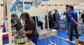 Women assembling mechanical parts in ESV company