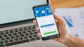 An image of a phone with Facebook displaying