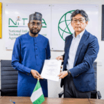 An image of two men holding a MOU