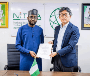 An image of two men holding a MOU