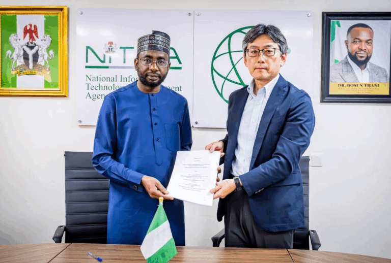 An image of two men holding a MOU