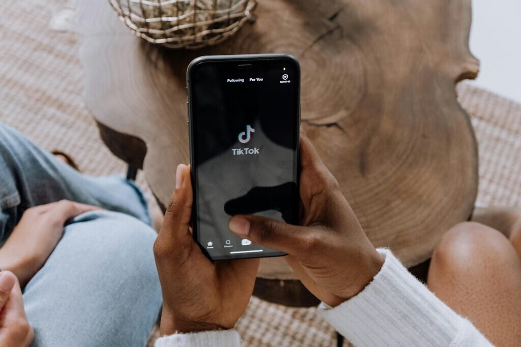 Hand scrolling through Nigerian music on TikTok